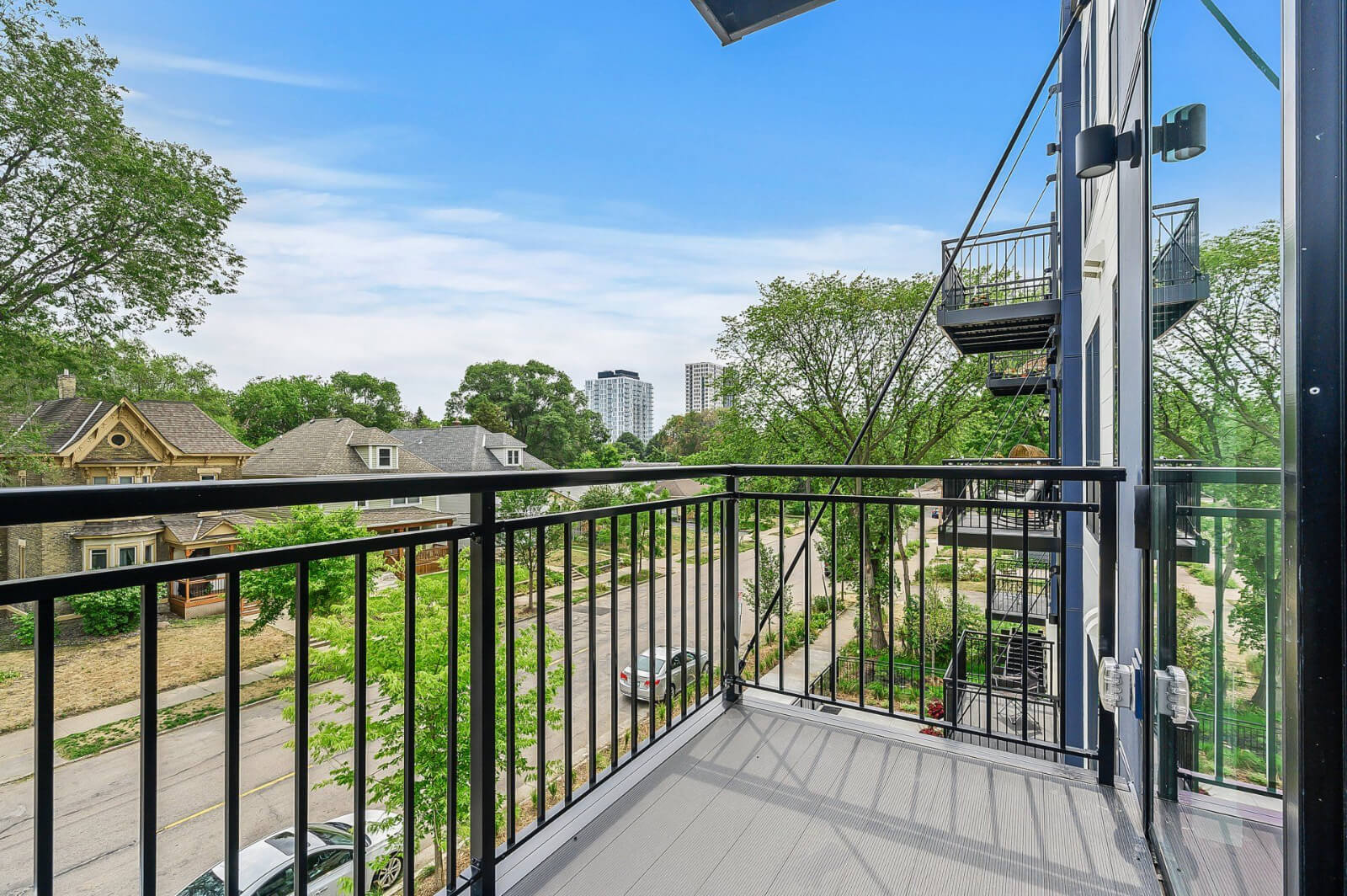 the view of the street from an apartment balcony