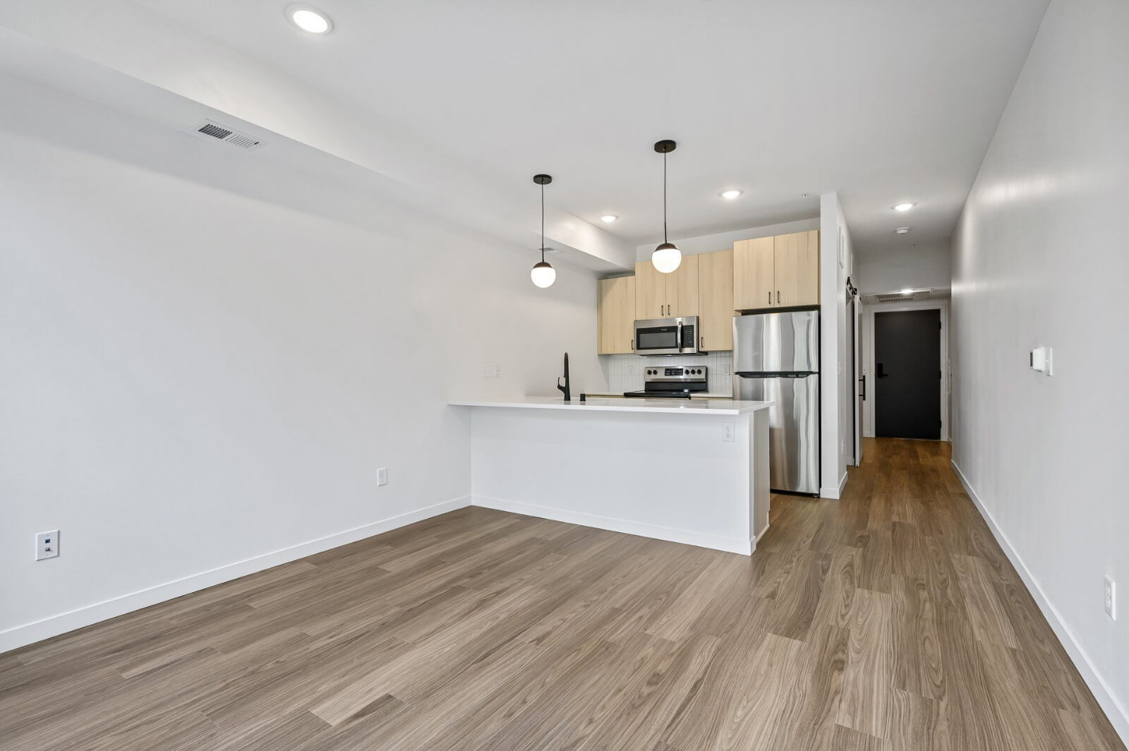 an empty apartment living room and kitchen