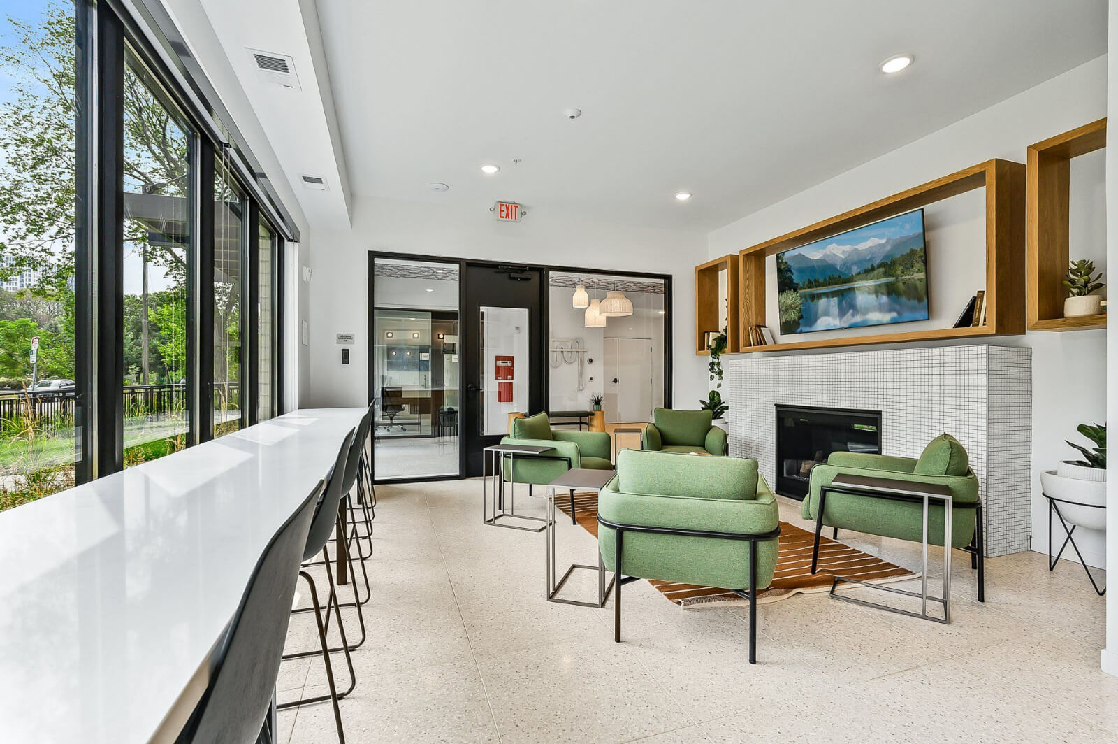 the community lounging area with a tv and fireplace