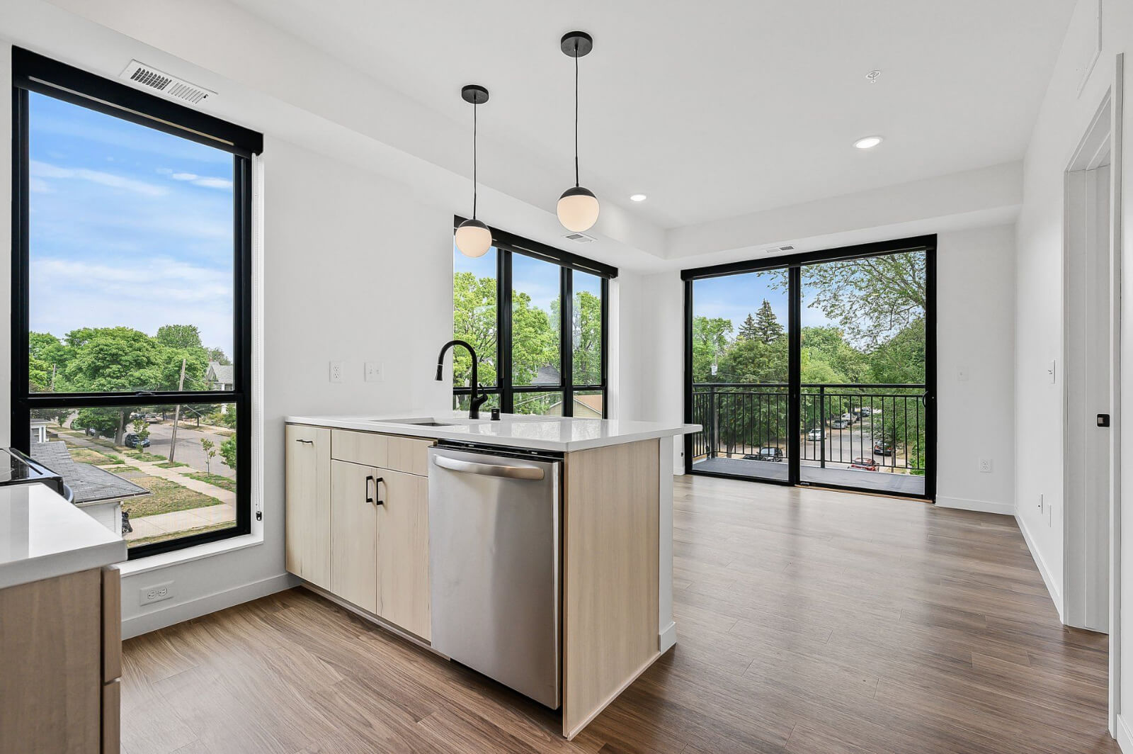 an empty apartment kitchen and living room